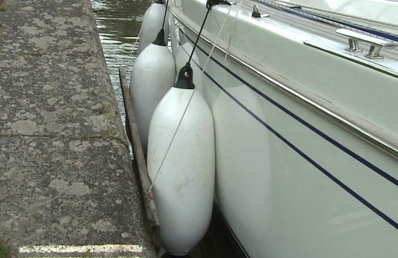 fenders-and-board-sailboat-canal